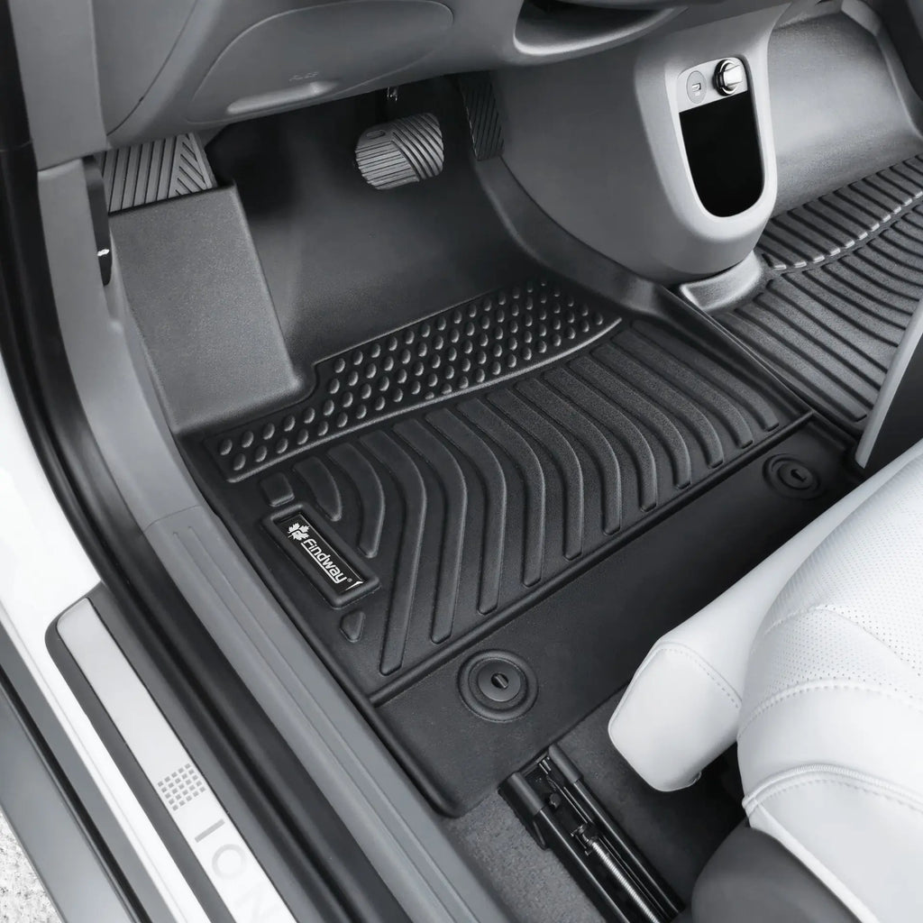 Car interior with black All-Weather Floor Mats on a gray car floor.