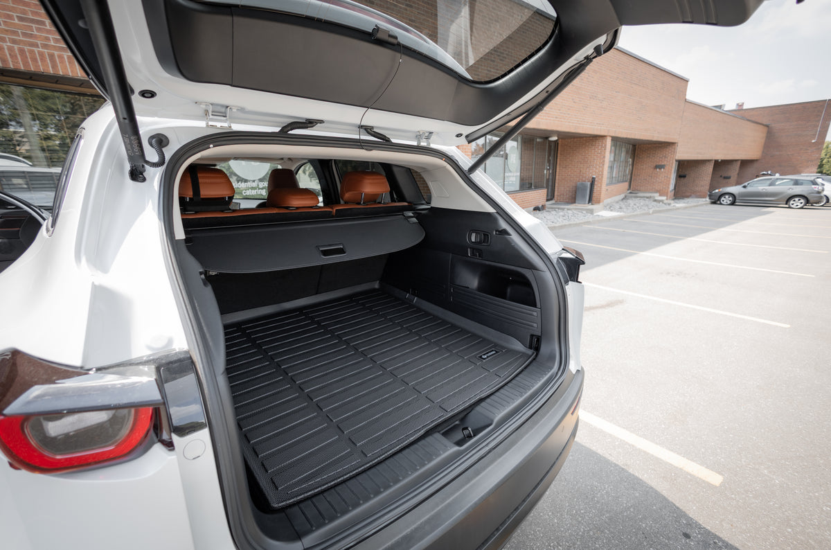 Open car trunk with a Findway cargo mat in a parking lot