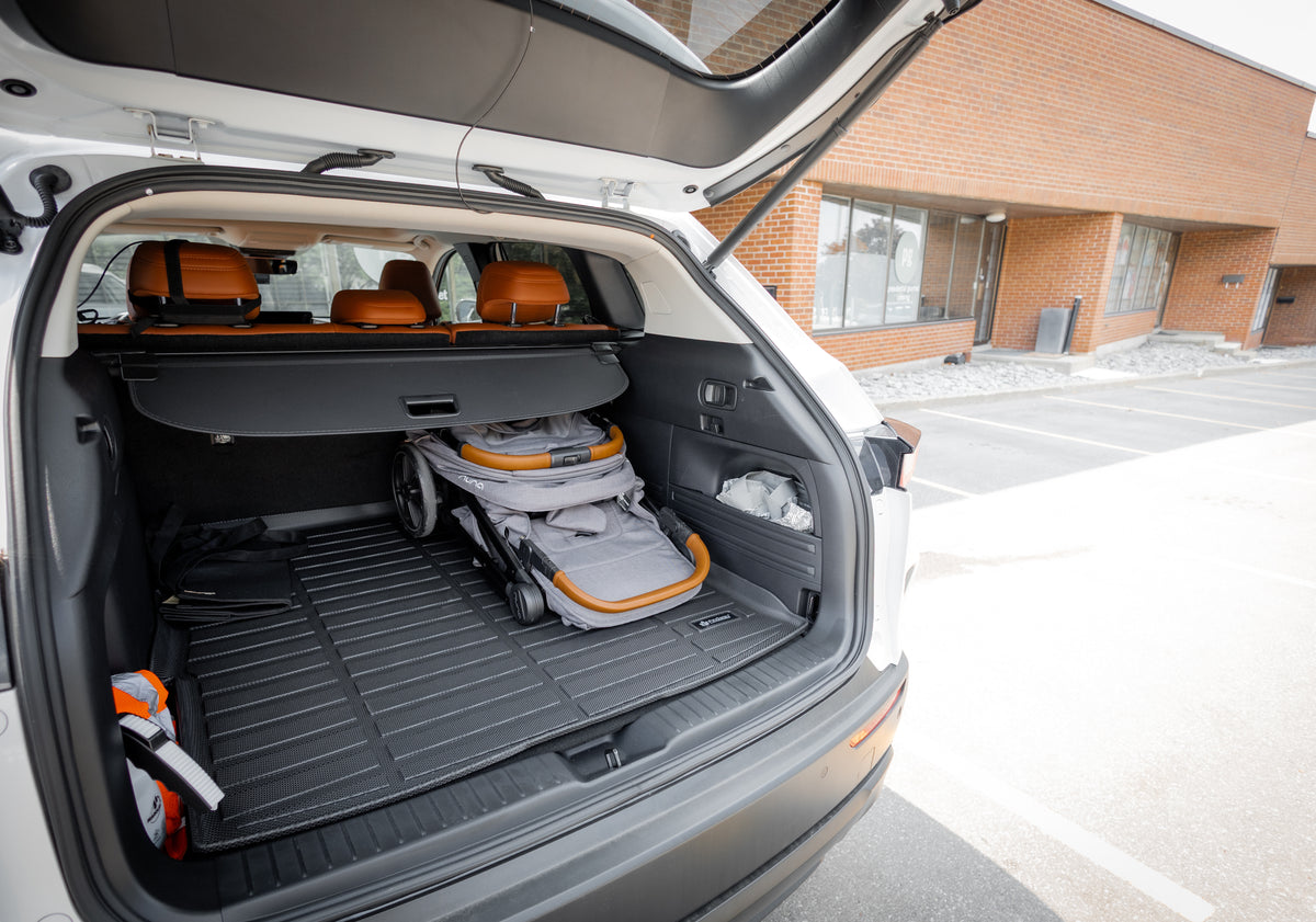 Open car trunk with a baby stroller on the Findway cargo mats at the parking lot
