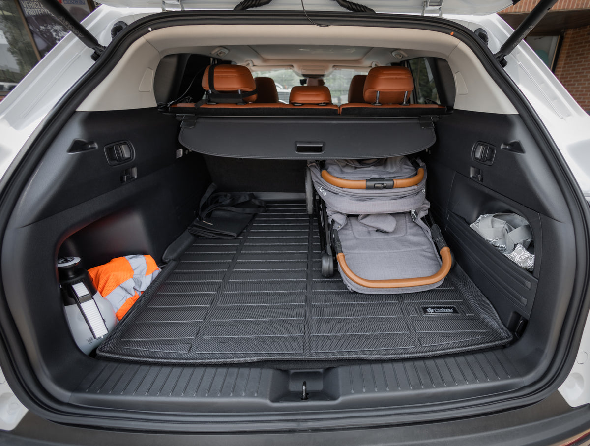 Open car trunk with a folded stroller inside, showing storage capacity and the Findway cargo mat.